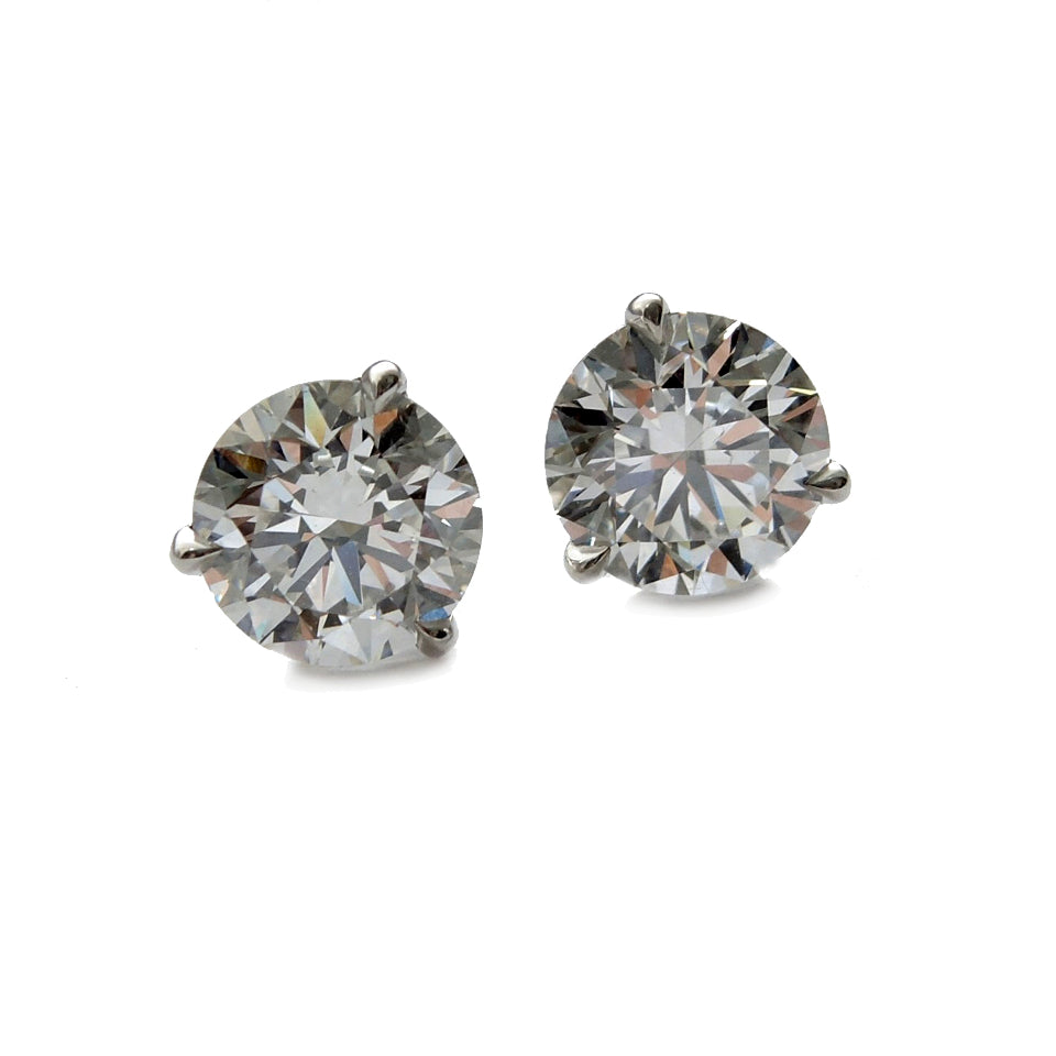 Platinum martini studs with 3.0 tcw. lab grown diamonds with one at and angle.