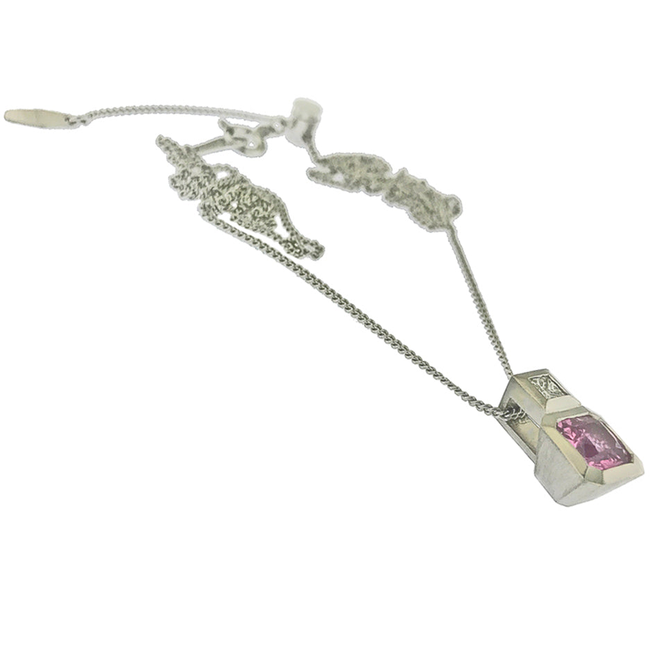 Side view of pendant and chain, bezel set pink sapphire with diamond bail