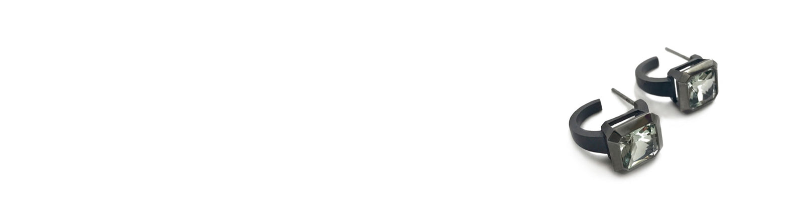  The earrings are viewed from the side to show the S20 blackened silver 3/4 hoops, with bezel set 8mm radiant green amethysts.