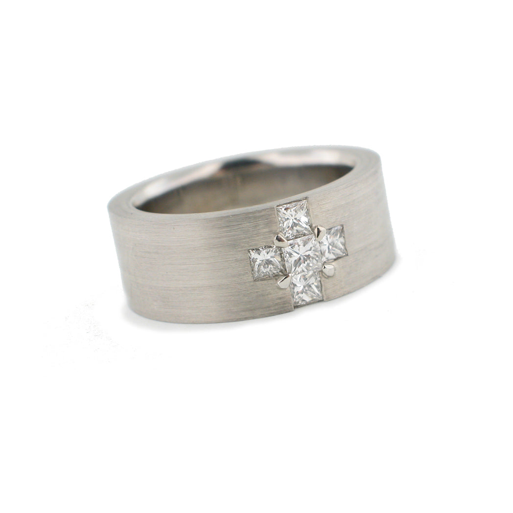 Wide band ring in 18K white gold with 5 princess cut diamonds forming a cross at the center. 