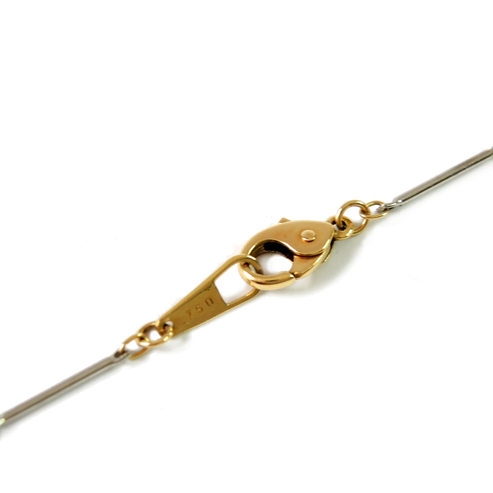 Gold lobster clasp on platinum/18k bar chain.