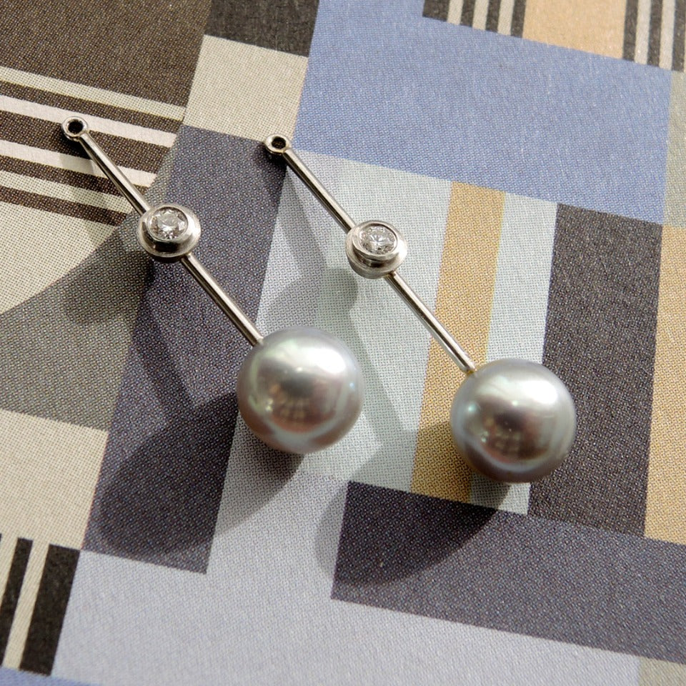 8mm pearl stud shown with long pearl jacket with bezel set .10 tcw. diamonds