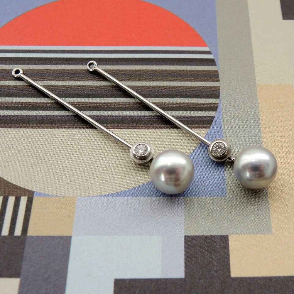 Long Pearl Kackets with small bezel set diamonds and 8mm blue pearls