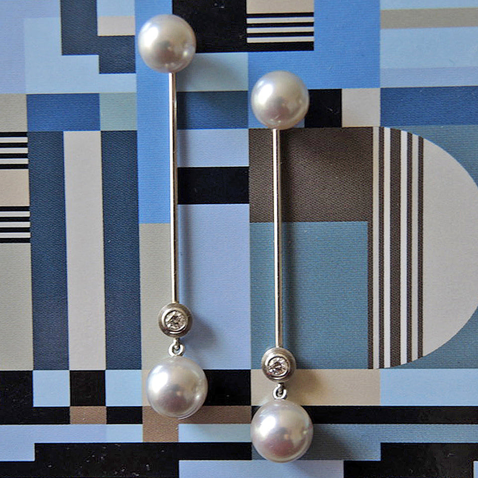 8 mm pearl studs with long jackets with .10 tcw. bezel set diamonds