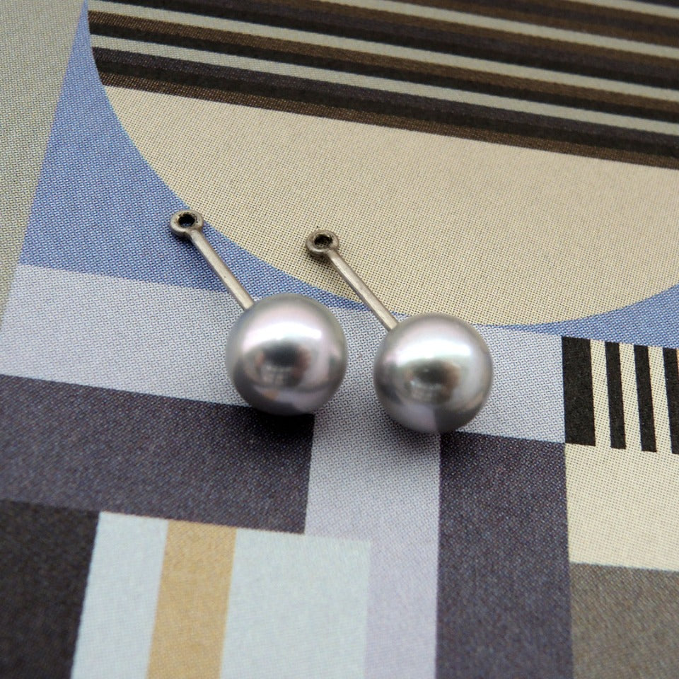 Pale blue pearl studs with pearl jackets on a 9mm stem