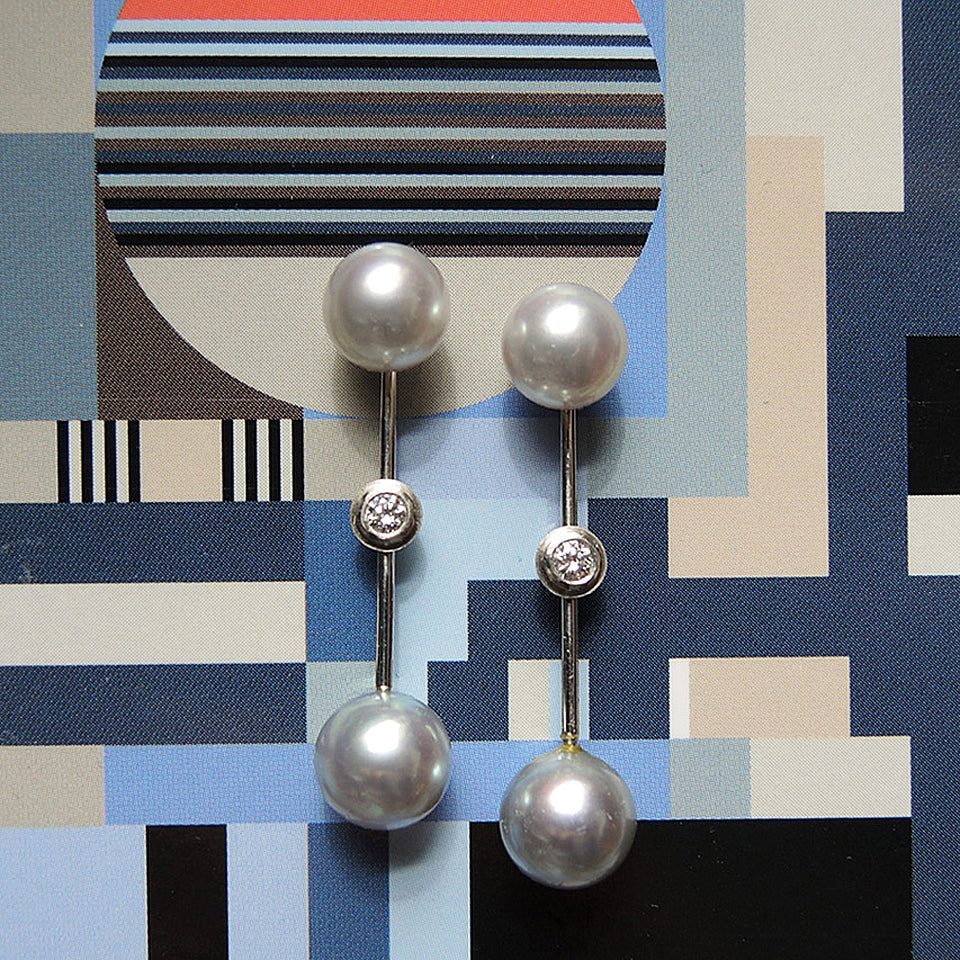 8mm pearl stud shown with long pearl jacket with bezel set .10 tcw. diamonds