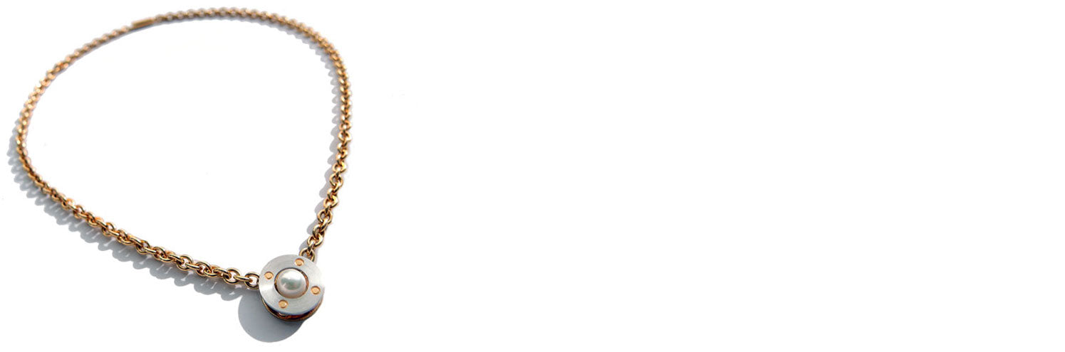 Gold necklace with a modern pearl pendant on a white background