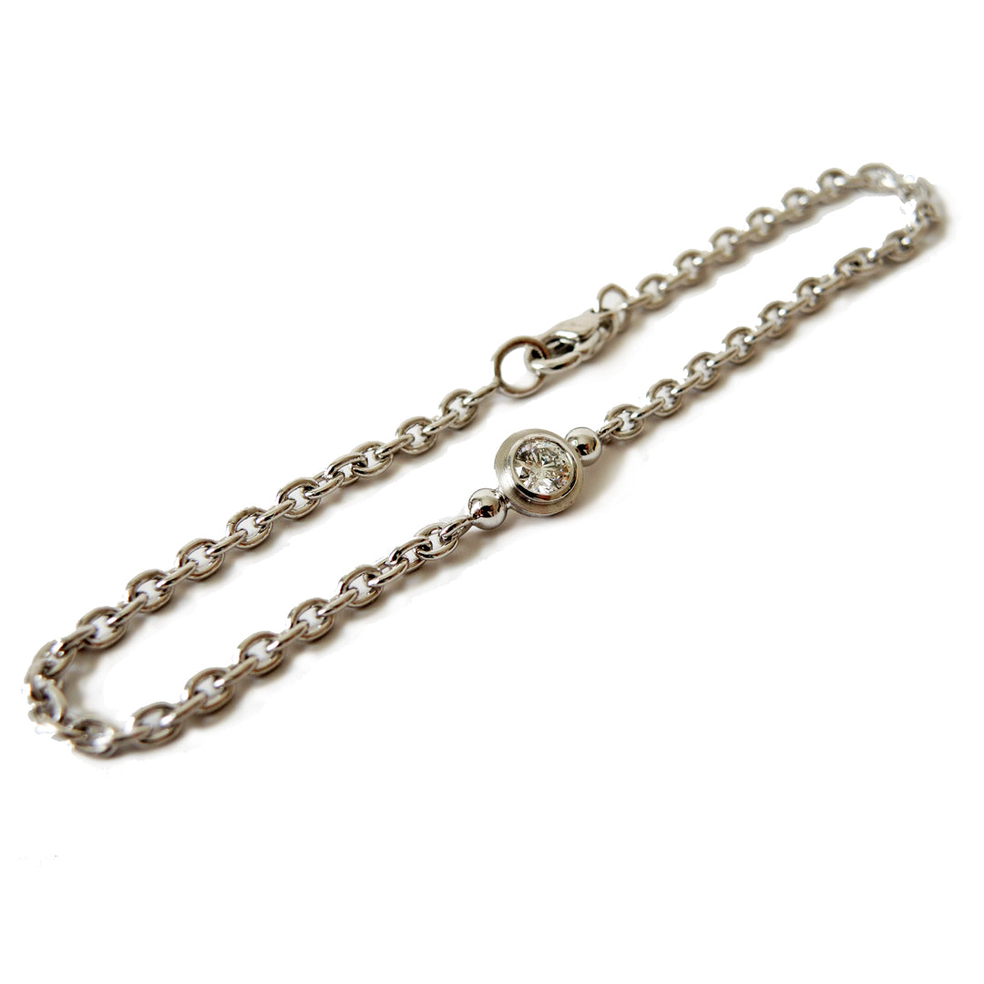 Platinum chain bracelet with a .25 ct. diamond  and a lobster clasp on a white background.