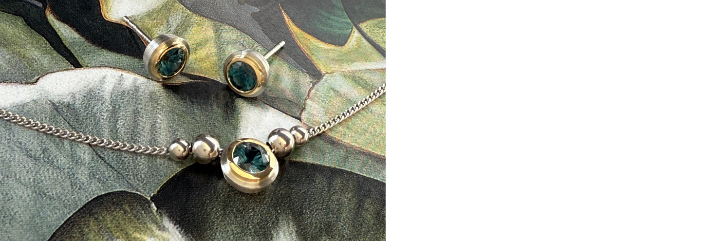 Bezel set pendant and earrings with Montana sapphires on watercolor background