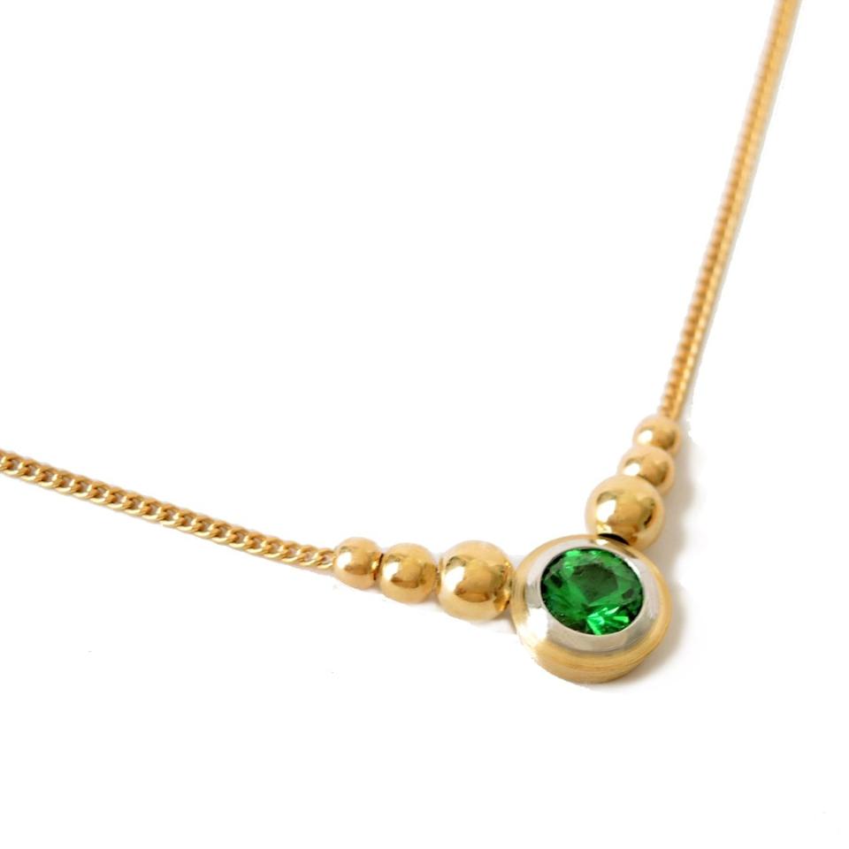 5 mm tsavorite in a double bezel, platinum and 18K gold on a fine gold chain with 6 graduated beads