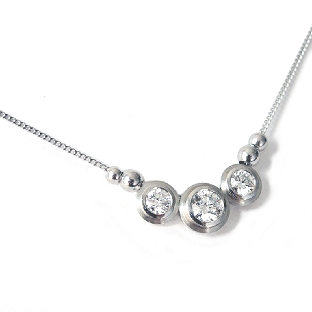 Series 8 - Simplicity | Bezel, Three Stone Pendant in Pt., .25 ct. and 2 x .12 carat diamonds