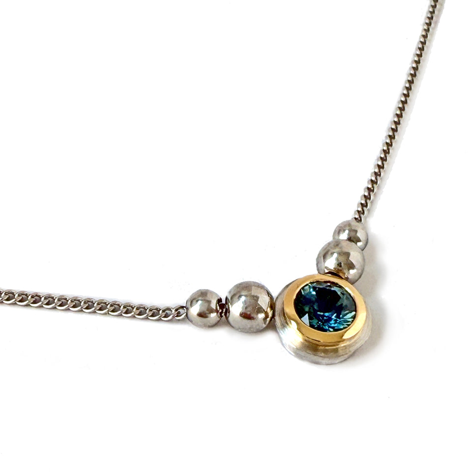 Montana blue-green sapphire bezel set in 18k yellow gold and platinum on a fine chain.