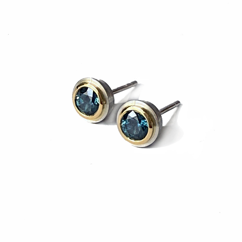 Simplicity Studs in 18 and platinum bezels with Montana sapphires, both facing forward.