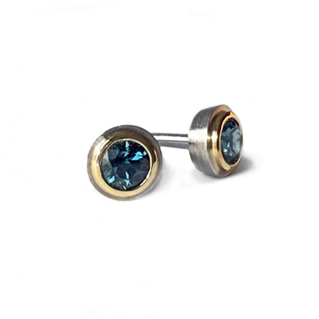 Simplicity Studs in 18 and platinum bezels with Montana sapphires, both facing forward.